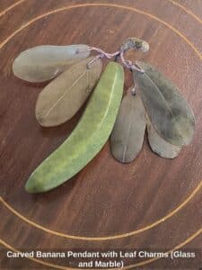 Carved-Banana-Pendant-with-Leaf-Charms-Glass-and-Marble