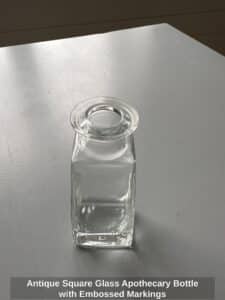 Antique-Square-Glass-Apothecary-Bottle-with-Embossed-Markings