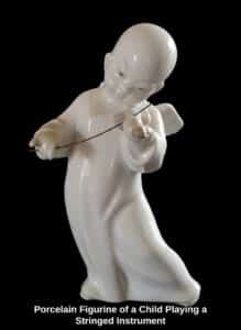 Porcelain-Figurine-of-a-Child-Playing-a-Stringed-Instrument