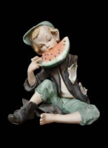 Giuseppe-Capp-Capodimonte-Porcelain-Figurine-of-a-Boy-Eating-Watermelon