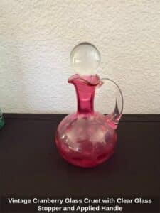 Vintage-Cranberry-Glass-Cruet-with-Clear-Glass-Stopper-and-Applied-Handle-second-image
