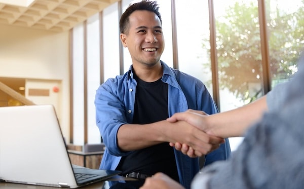 Businessmen shaking hands for business agreement in office